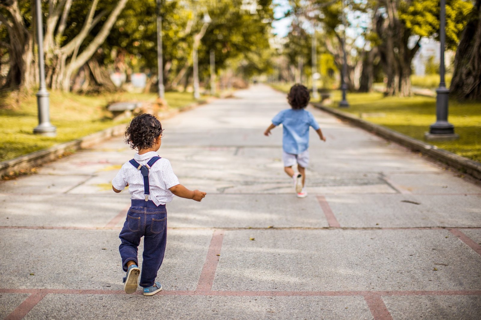 Cute picture of children running down a sidewalk